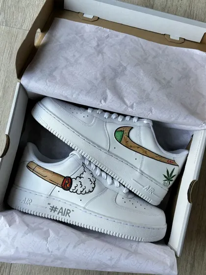 The RAW-themed custom sneakers displayed in their box.