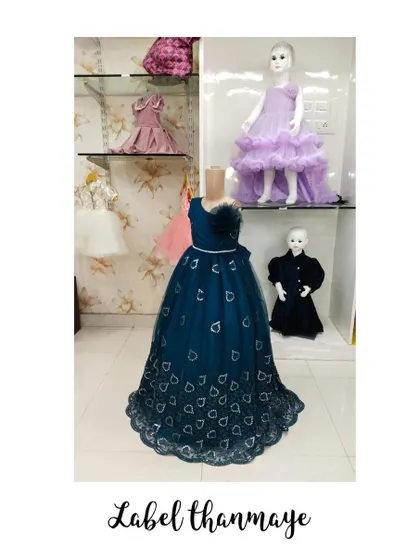 This long teal gown has a beautiful heart-patterned fabric and a flower detail at the waist.