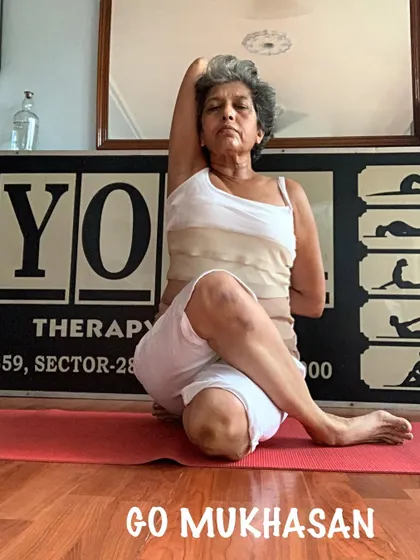 A front view of the Gomukhasan arm bind, showing the shoulder-opening benefits. This helps to counteract the rounding of the shoulders that can happen during pregnancy.