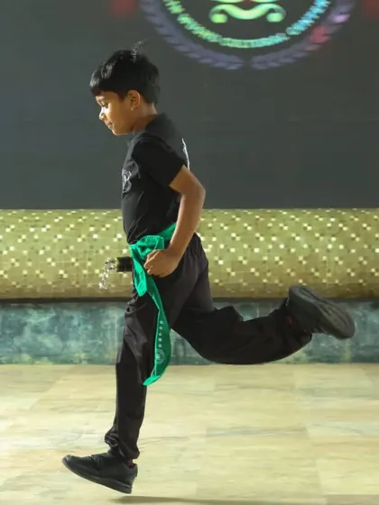 A young student demonstrates dynamic movement during our 2nd black belt ceremony. His posture and energy show the confidence that martial arts training builds.