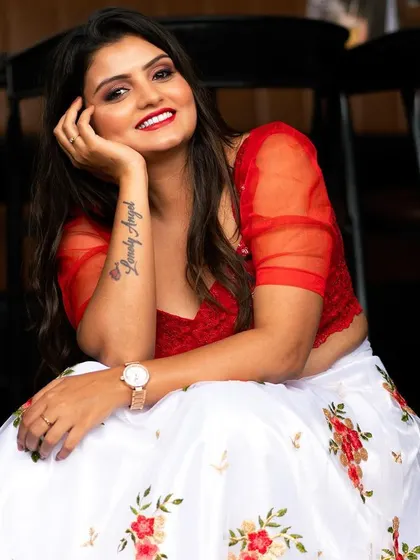 A bright and joyful portrait in a red and white lehenga. The model's happy expression and the vibrant colors make this a very lively image.
