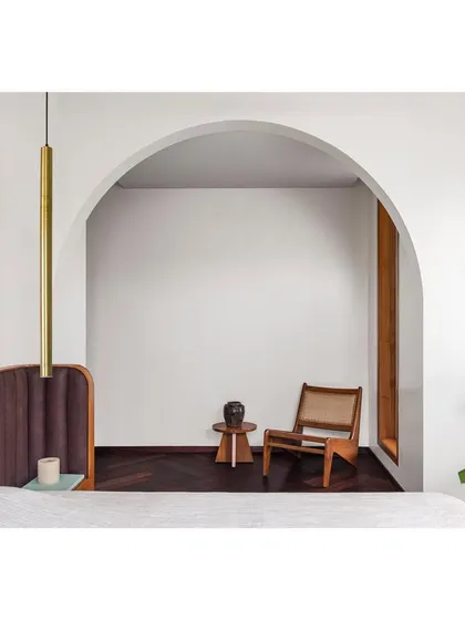 The arch motif is a recurring element I use to soften transitions and create elegant focal points. Here, it frames a quiet reading corner, making the space feel curated and special.