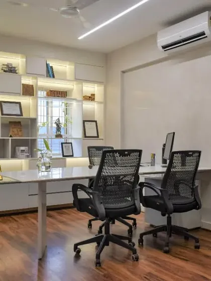One of the director's cabins in the SAS office. A glass partition maintains a connection to the main studio, while a backlit shelving unit provides ample space for displaying books, models, and awards.