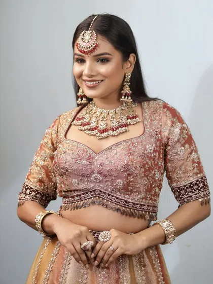 A full portrait of the 'Riwayat' look, showcasing how the dewy base, shimmery lids, and bronzed skin come together for a timeless and traditional bridal style.