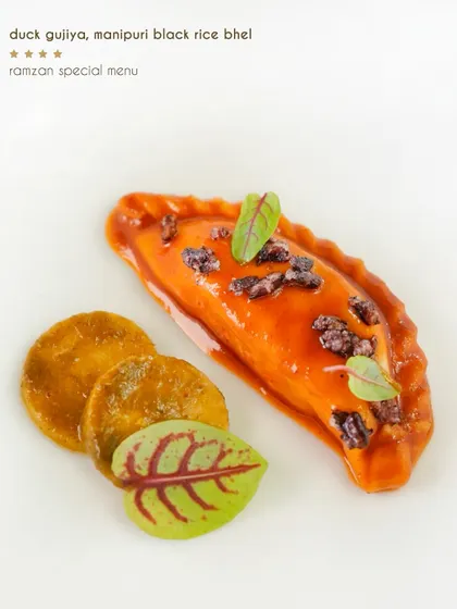 A traditional gujiya pastry is given an inventive twist, filled with savoury duck and served with a Manipuri black rice bhel for a surprising crunch.