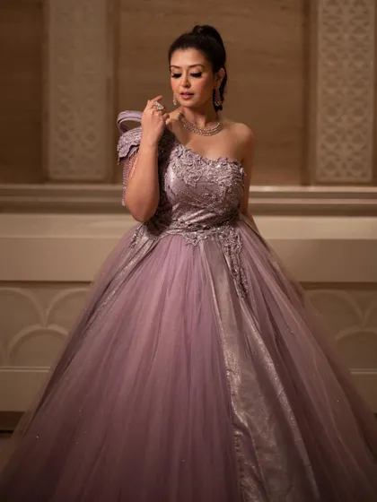 A full-length view of the royal lavender ball gown, showing its grand silhouette and modern, asymmetrical design. It's a perfect choice for a bride who wants a unique and memorable look.