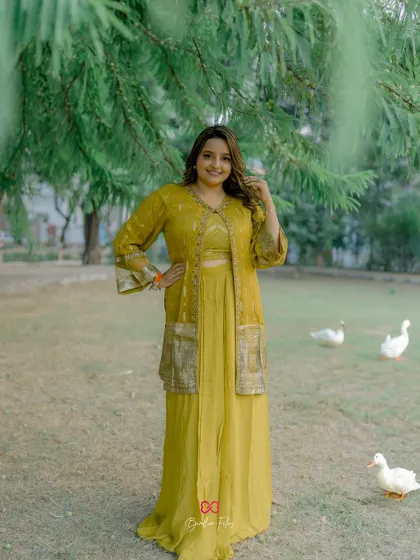 A lovely outdoor portrait of the bride in her yellow Haldi outfit, with some friendly ducks adding a whimsical touch to the scene.