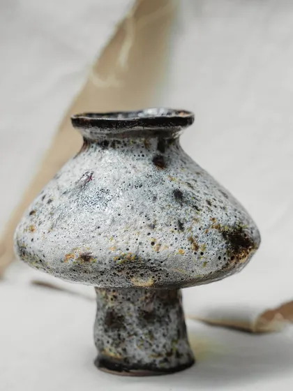 This mushroom-shaped vase with a heavily textured, volcanic glaze is a wonderful example of the experimental work our students produce. It's a celebration of unique forms and the unpredictable beauty of glazing.
