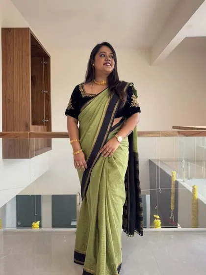 Our client looking elegant in a green saree with a custom-embroidered black velvet blouse.