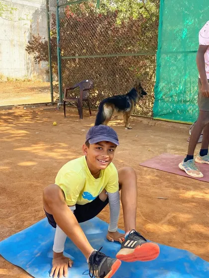 A candid moment of a player stretching on a yoga mat post-training, emphasizing our focus on recovery and flexibility.