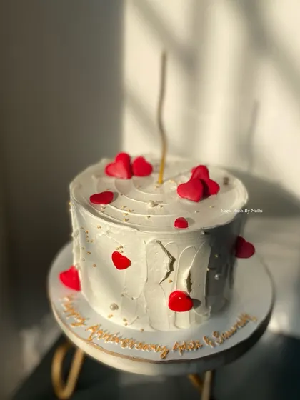 A sweet and simple anniversary cake with a rustic finish and little red hearts. The handwritten message on the board adds a personal touch.
