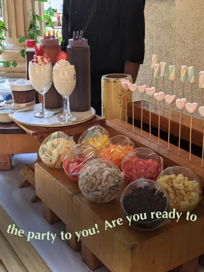 A hot chocolate or milkshake station for a kids' party, complete with marshmallows and various toppings. Interactive stations like this are a great way to keep the little ones entertained.