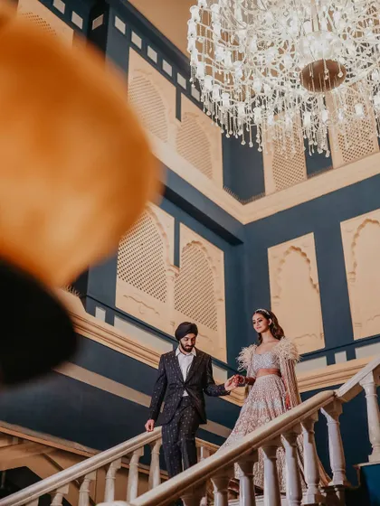 A behind-the-scenes look at me capturing the couple's grand entrance down the staircase during their Sangeet. This shows my unobtrusive, documentary approach.