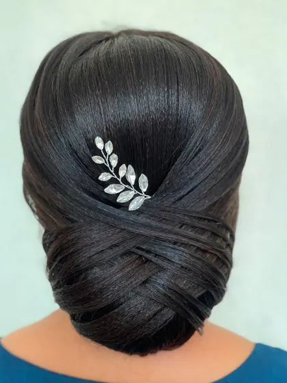 The sleek and polished finish of this French twist bun makes it a perfect choice for any formal event. It's a style that never goes out of fashion.