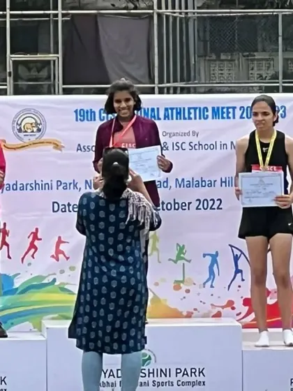 The podium ceremony for the girls' 600m run, where my athlete Dhwani Thakkar won a bronze medal.