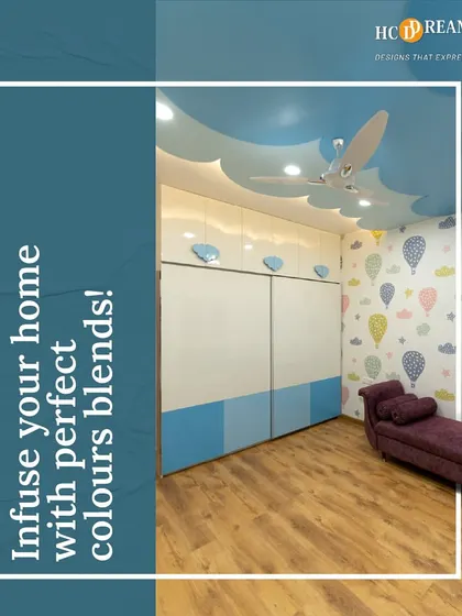 A whimsical kid's room with a cloud-themed false ceiling and hot air balloon wallpaper. The design sparks imagination and creates a playful, dreamy atmosphere.