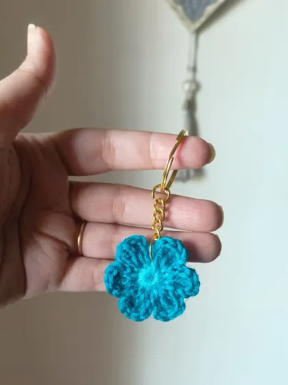 A floral keychain in a beautiful teal color. A simple and sweet handmade gift.