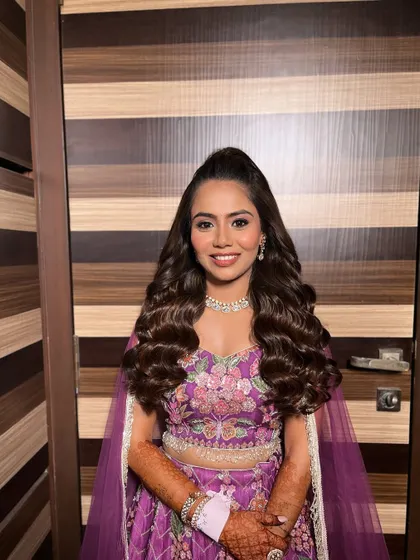 The client looking confident and beautiful. This half-up, half-down hairstyle is a popular choice for Sangeet and cocktail nights.