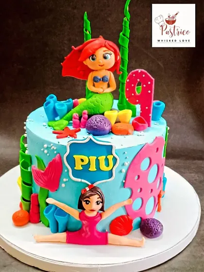 Another view of the detailed Little Mermaid and gymnastics cake, showing the colourful underwater scene.