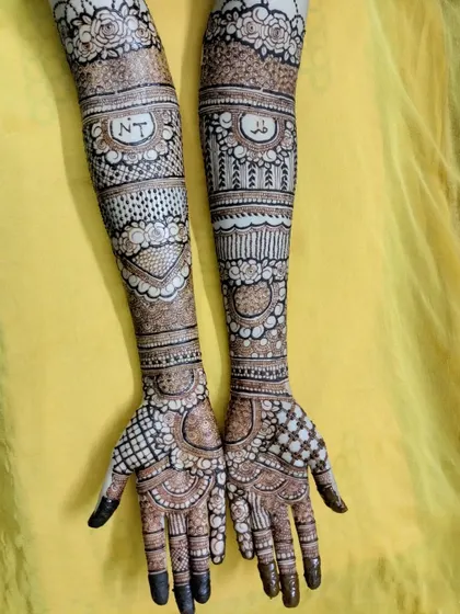 It was an honor to do this bridal henna for my cousin. I included her and her partner's initials, 'NT', in a special band on her arms.