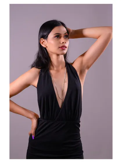 A close-up of the same look, allowing a better view of the delicate body chain and the model's expression.