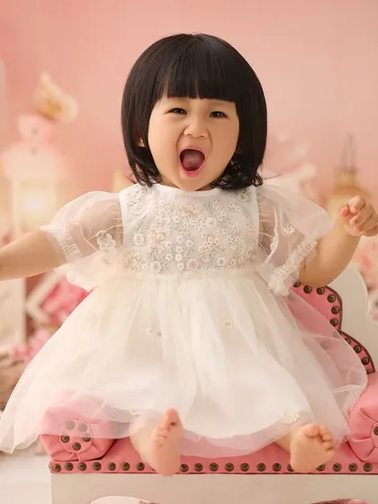 Capturing all the emotions of turning one, from big yawns to even bigger smiles. This expressive shot was taken right after her cake smash adventure.