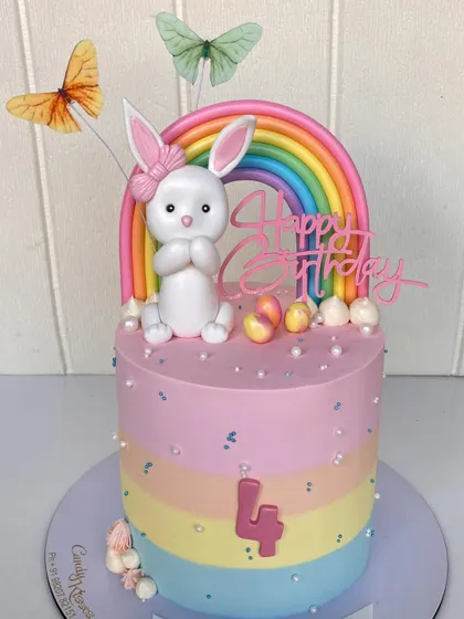 A pastel rainbow bunny cake made for a friend's daughter. This design features a cute bunny topper, a rainbow arch, and a surprise rainbow sponge inside.