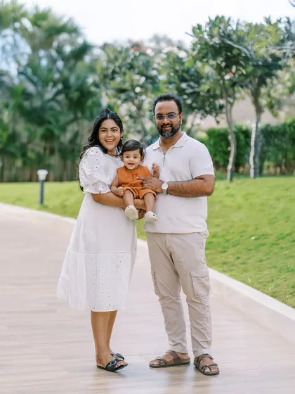 A family walking together in a park. The first year flies by, and capturing these everyday moments is so important.
