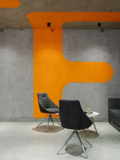 Another view of the lounge, showing how the organic orange shapes on the ceiling and walls define the seating area.