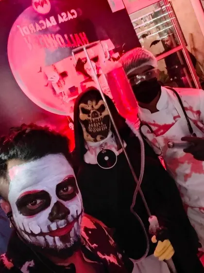Posing with guests in their amazing costumes during a Halloween event at Macaw.