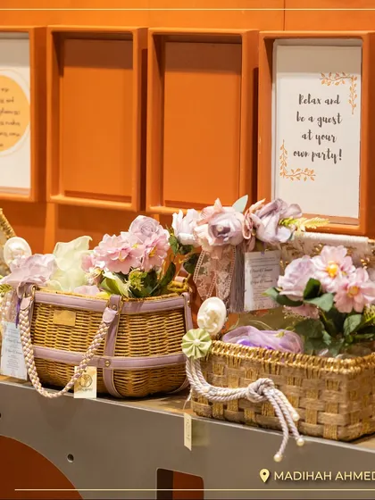 Another display in the Ahmedabad store, featuring our wicker and pastel-themed hampers. The wall art reminds clients to "Relax and be a guest at your own party!"