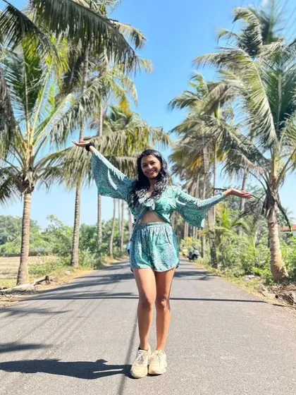 Posing on the famous 'Dear Zindagi' road in Goa. This shot captures a fun, carefree travel moment, perfect for tourism and lifestyle content.