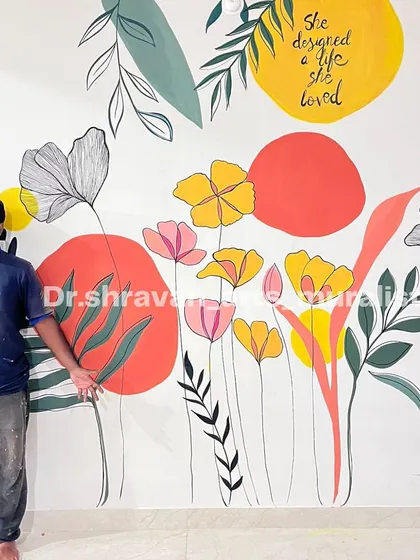 A cheerful boho foliage mural. The combination of simple line drawings, abstract color shapes, and a positive quote creates a space that feels personal and uplifting.