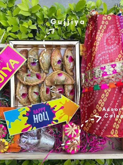 This Holi hamper is a complete celebration in a box. It includes a generous portion of my homemade gujiyas, assorted organic colors, fun Holi props, and a beautiful bandhani-print fabric wrap, making it a thoughtful and festive gift.