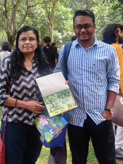 With a fellow artist at Cubbon Park, showcasing the art we created during our outdoor painting session.