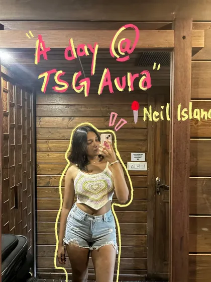 A day at TSG Aura, Neil Island. A mirror selfie gets a title card treatment with fun, handwritten text.