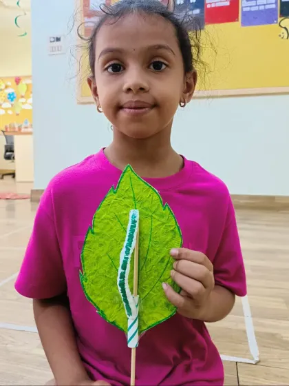 This camper proudly presents her finished moving caterpillar craft. Each child adds their own personal touch to their creation.