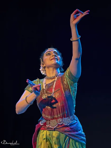 A moment of upward reach and devotion, captured during a live performance.