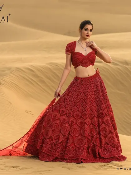 A full view of the ravishing red crop top lehenga, showcasing its intricate handwoven scallop design and delicate embellishments, perfect for the modern bride.