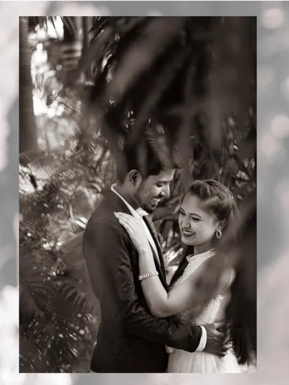 A romantic black and white photo of a couple framed by lush greenery. I often use natural elements to create depth and a sense of intimacy in my pre-wedding photography.