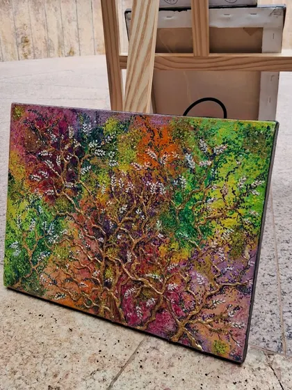 A vibrant, textured painting of a tree of life, showcasing a burst of color and creativity.