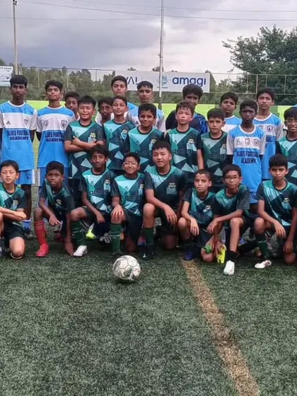 Our U13 boys team posing with Kickstart FA before an 11-a-side friendly match. These games are crucial for developing teamwork and discipline.