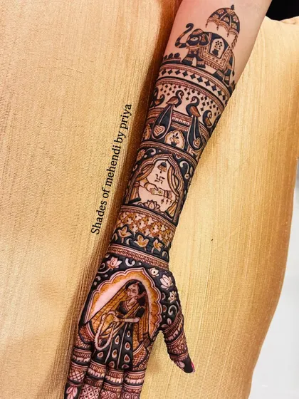 The complete arm design, showing how all the elements, from the bride in her doli to the royal elephant, come together to create a stunning bridal mehendi.
