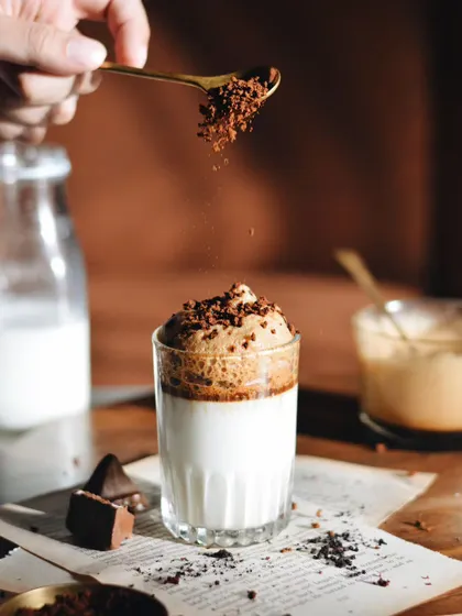 A throwback to the Dalgona coffee trend. This shot captures the distinct layers and fluffy texture of the coffee, shot in a warm, inviting style.