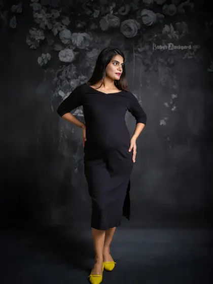 Modern, chic, and glowing. This studio portrait with a floral backdrop shows that maternity style can be both elegant and contemporary.
