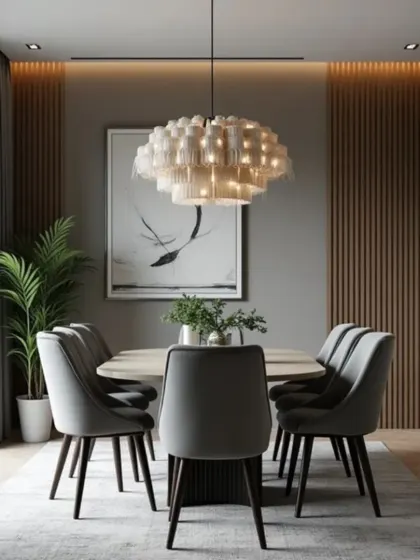 We used a layered fringe chandelier to add texture and a unique design element to this intimate dining space. The back wall features wood paneling that adds warmth, contrasting with the cool grey tones of the chairs and rug.