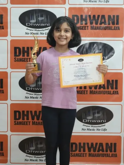 A young achiever proudly displays her award. We believe that celebrating small and big wins is key to a student's long-term motivation.