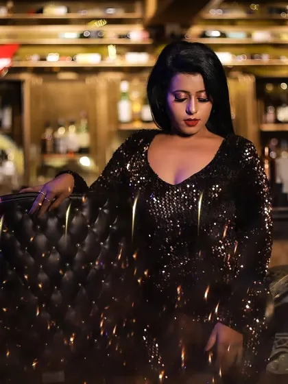 Another shot from the party-wear photoshoot. The focus is on the dramatic eye makeup and contoured features, creating a high-fashion, editorial-style look.