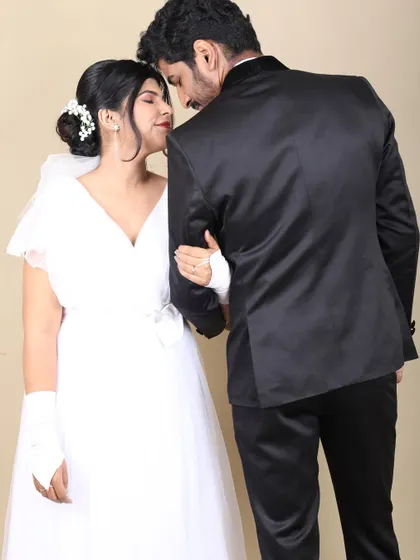 A beautiful, intimate shot of the couple. The bride's classic updo and soft makeup create a timeless and elegant wedding look.