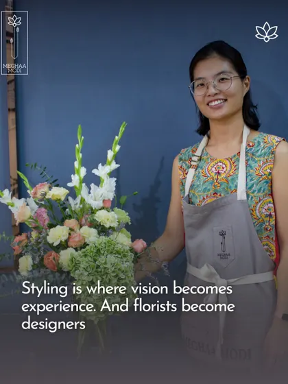 Styling is where vision becomes experience, and florists become designers. This student is proudly displaying her work, which shows a strong sense of composition and style.